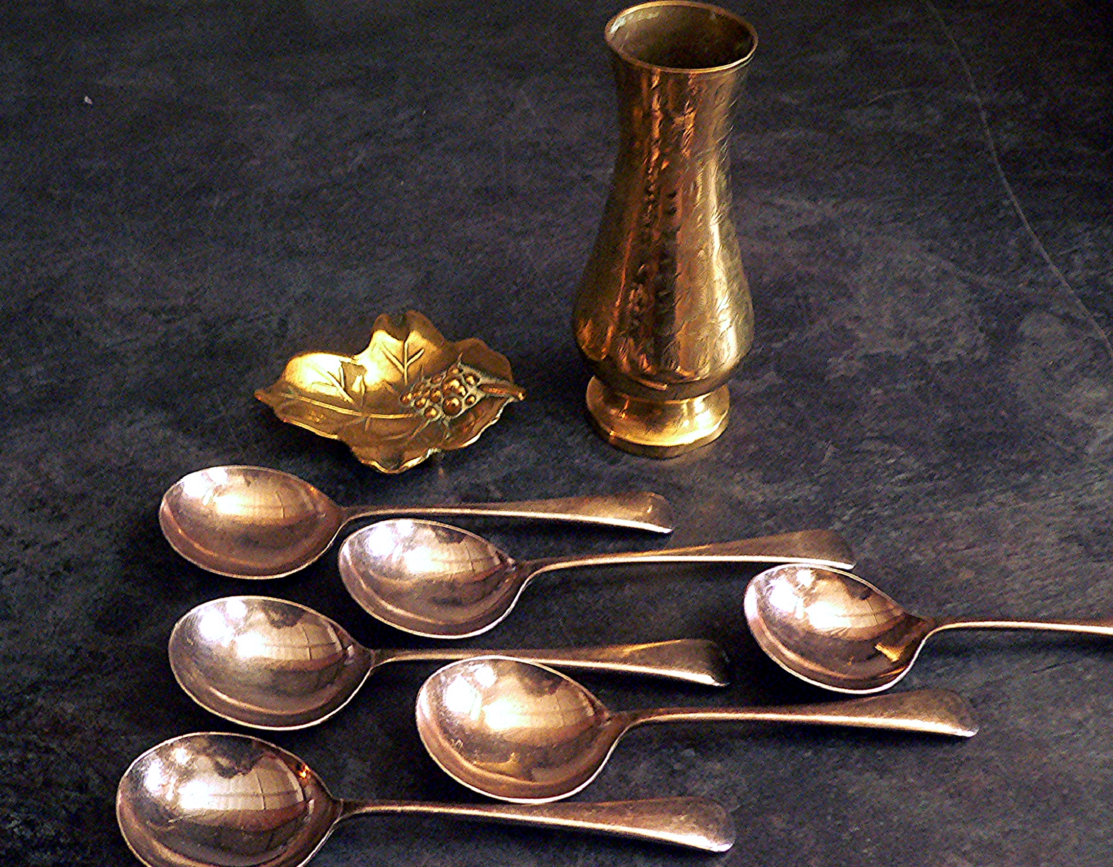 Heavy silver plated spoons, a brass leaf trinket dish and a brass vase