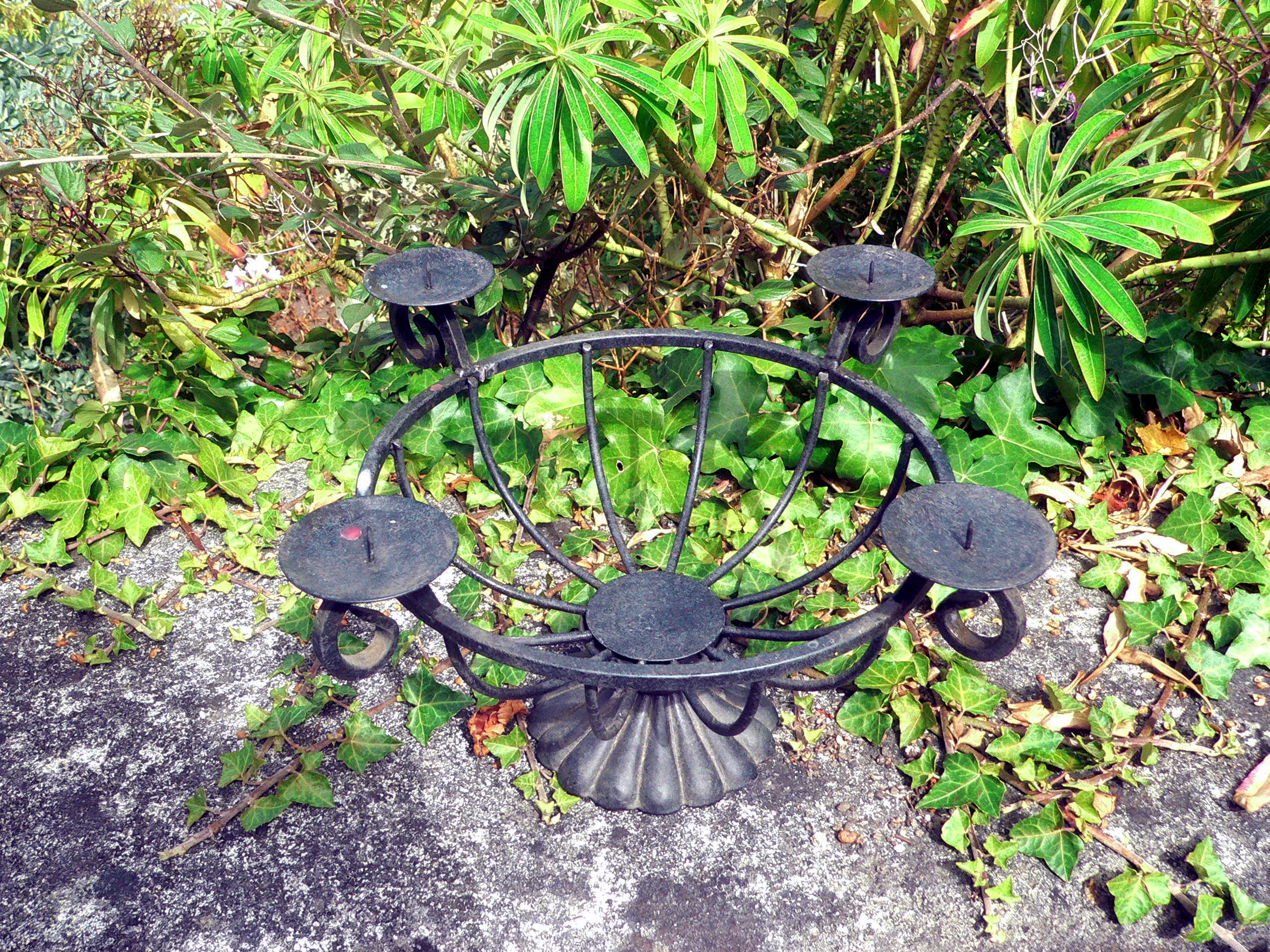 Large, heavy, solid metal plant pot holder / Punch bowl holder with bases for four large candles.