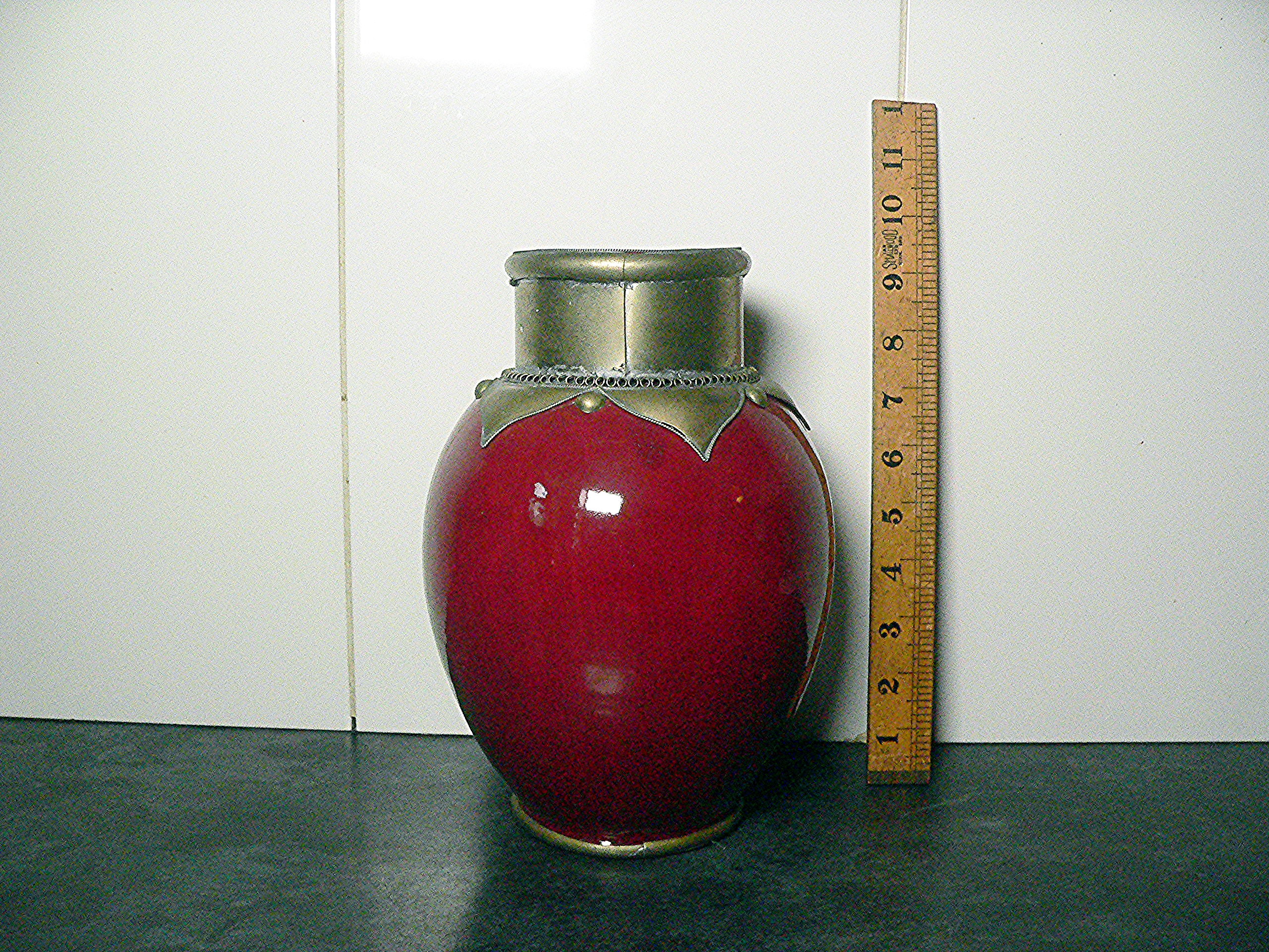 Unusual ceramic vase with a metal collar.