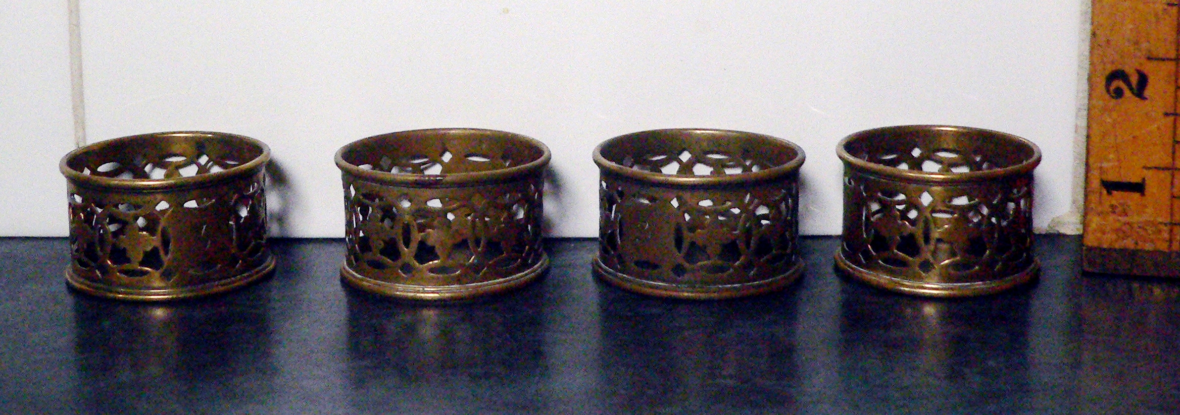 Two pairs of brass napkin rings.