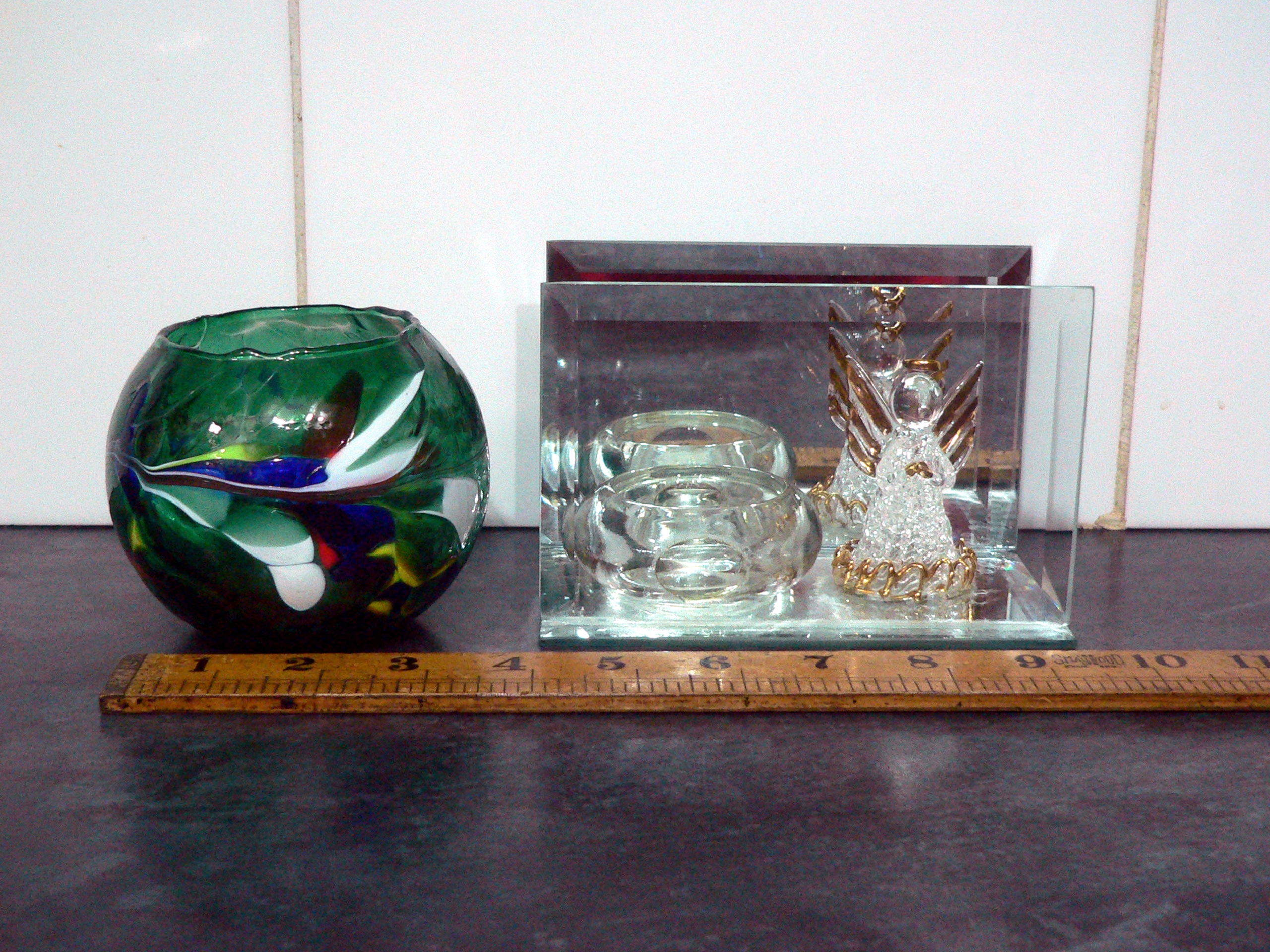 Pair of glass tealight candle holders, one is mirrored