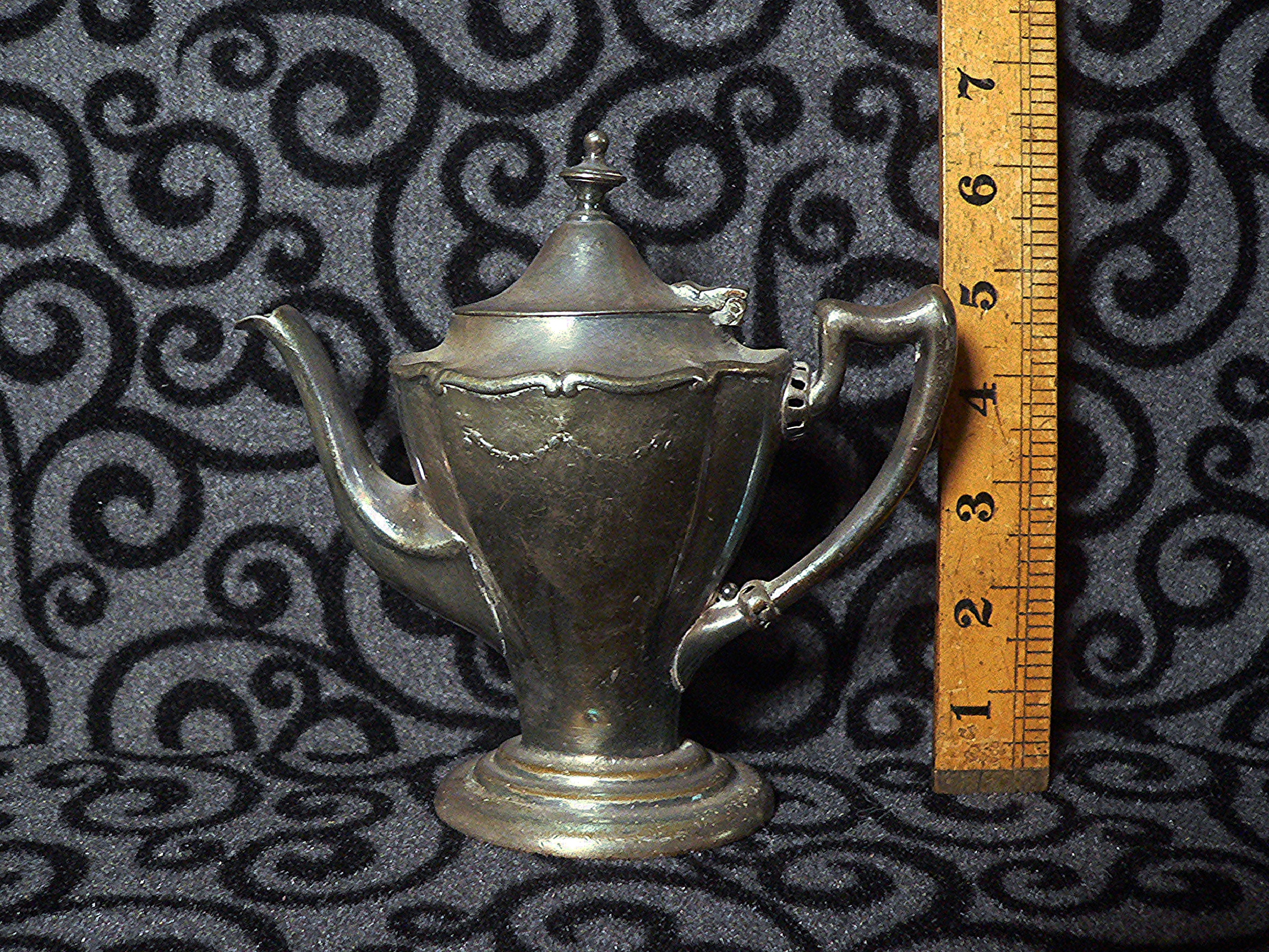 Unusual plated teapot on brass