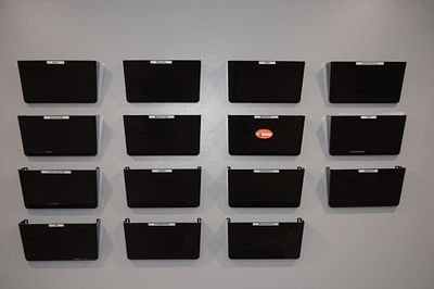 A Set of Sixteen Modern Black Plastic. Wall-Mounted