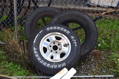 Group of Three Used Automotive Tires, One Mounted