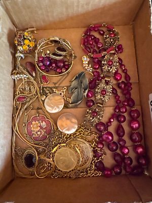 An Assortment of Vintage Costume Jewelry including Necklaces, Brooches, and Pendants. This 