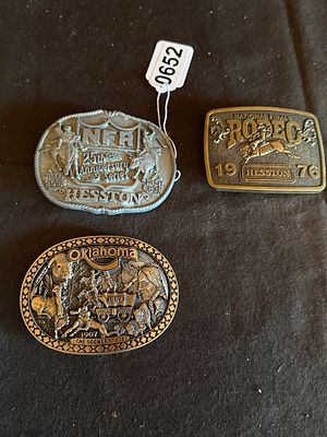 Three Commemorative Cast Metal Belt Buckles Including Hesston National Finals Rodeo. Three 