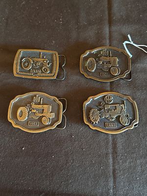 A Collection of International Harvester Commemorative Tractor Belt Buckles. A collection of 
