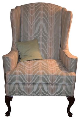 Queen Anne Style Upholstered Wingback Armchair. A Queen Anne style wingback armchair featuring a 