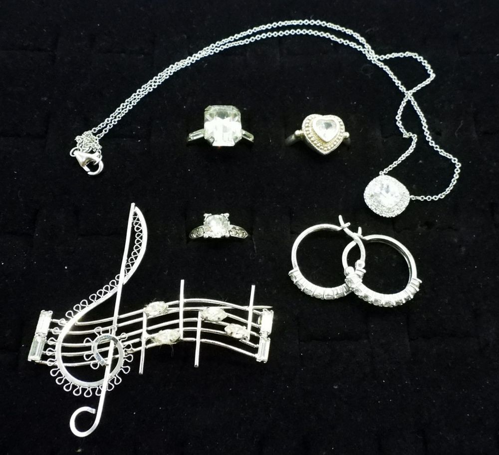SIMULATED DIAMOND 925 RINGS, PIN & MORE. THREE STERLING RINGS, SIZES 6, 7, 8. MUSIC NOTE PIN, 2" 