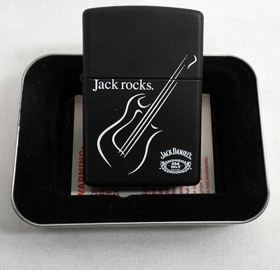 1999 UNFIRED JACK ROCKS GUITAR ZIPPO. UNFIRED, FROM 1999, IN A ZIPPO TIN CASE, JACK ROCK WITH A