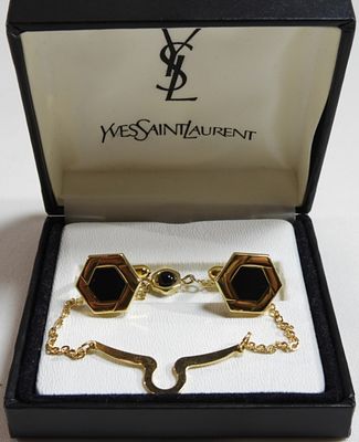 Pair Of Cuff-links. Like new in the box. Gold tone with an onyx color stone