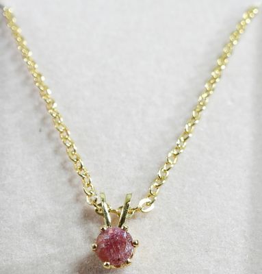 Necklace. Like new in the box. Gold tone and red stone