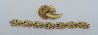 Trifari Brooch and Bracelet. 7 1/2" bracelet with gold tone feather design, and 2 1/2" gold tone 