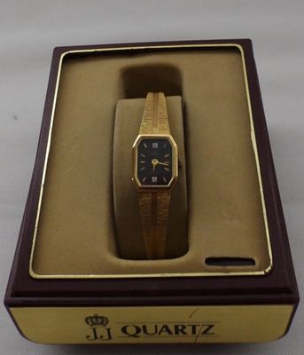 Women's Gold Tone Quartz Watch. Gold tone with two clear stones on the face. Steel back base 