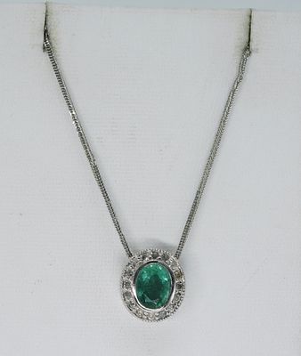 14k White Gold Emerald Diamond Necklace. 14k white gold chain and pendant with center emerald 