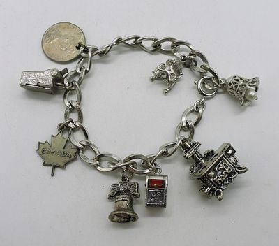 Sterling Vintage Charm Bracelet - 8 Charms. Vintage sterling charm bracelet with 8 charms, 7". 
