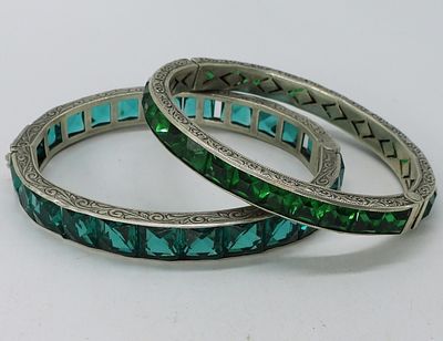 2 Sterling Green Rhinestone Bracelets. Two sterling hinged bracelets with princess cut green 