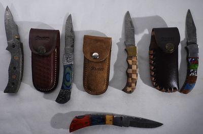 Five Damascus Blade Folding Knives. Three come with Stauer leather sheaths. it is not opening.