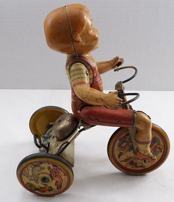 Kiddy Cyclist Unique Art Tin Toy. Tin plate, works when held in the air, but does not move when 