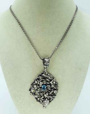 Unique Sterling Blue Topaz Necklace. Unique sterling pendant with blue topaz gemstone on a 