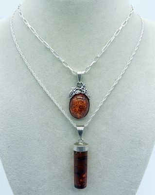 Two Sterling Amber Necklaces. Two sterling necklaces with Amber gemstone pendants. Chains are 