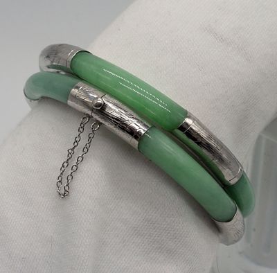 2 Sterling and Jade Hinged Bracelets. Two sterling and Jade hinged bracelets. Both have safety 