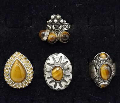 Four Sterling Tigers Eye Fashion Rings. Four sterling tigers eye gemstone rings. One size 8 and 