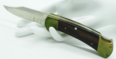 Buck 112 Lock-Back Pocket Knife. Very sharp with a wooden handle. Jylan 200 is etched on the handle