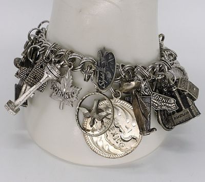 Vintage Sterling Charm Bracelet - 24 Charms. Vintage sterling charm bracelet with 24 charms, 7" 