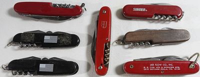 Multi-Tool Knife Collection (7 pieces). Collection includes 2 red Colonial handles, 1 red Wenger 