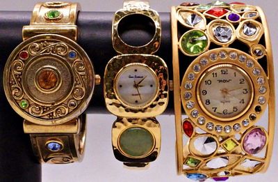 Three Gold-Tone Cuff Watches, Quartz. Lot of three gold-tone cuff watches, each featuring a 