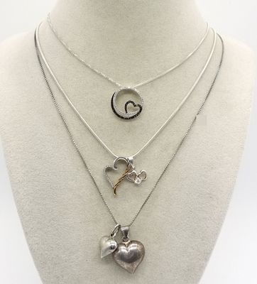 2 Diamond Necklaces & More. Three marked sterling silver 18-inch chains supporting five 