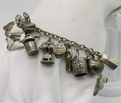 Sterling Charm Bracelet with 24 Charms. Sterling silver 8-inch charm bracelet featuring 24 