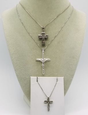 Three Sterling Cross Necklaces. Three distinct sterling silver cross pendants, each suspended 