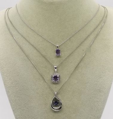 Three Sterling Amethyst Pendant Necklaces. Three sterling silver pendants featuring purple 
