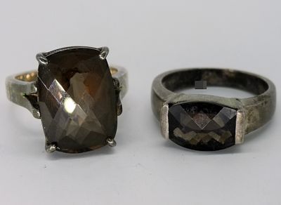 Two Sterling Smoky Quartz Rings. Two marked 925 sterling silver rings featuring checkerboard-cut 