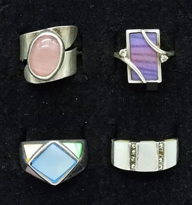 4 Sterling Mother of Pearl Ring Lot. Four sterling silver rings featuring mother of pearl inlays 