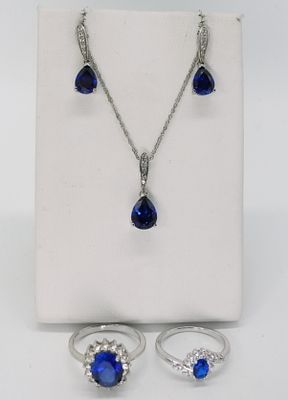 Sterling Simulated Sapphire Jewelry Set. Two sterling rings in sizes 7 and 8, drop earrings 