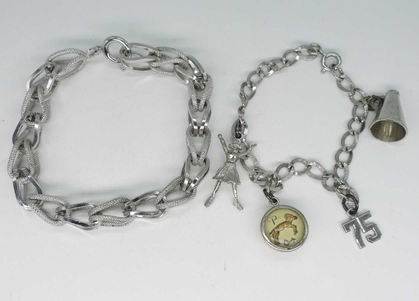 Two Sterling Charm Bracelets, 7 Charms