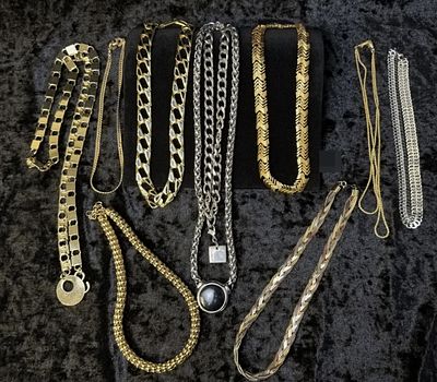 10 Mixed Tone Necklaces. A collection of 10 costume necklaces in varied gold-tone and 