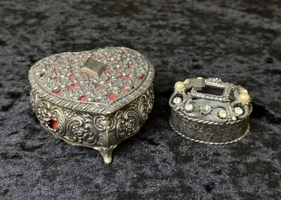 Silver-Tone Trinket Boxes. A pair of silver-tone metal jewelry boxes with raised floral and 