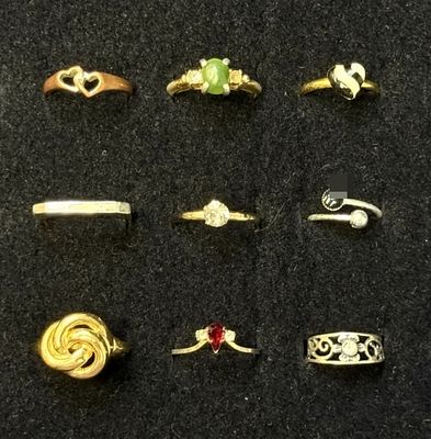 9 Pc Rings. A lot of nine costume rings in mixed gold-tone and silver-tone finishes, arranged in 