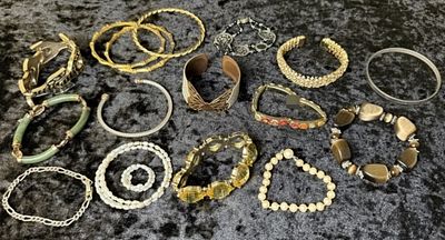 16 Bracelets. A varied lot of 16 costume bracelets in mixed tones, including gold-tone bangles 