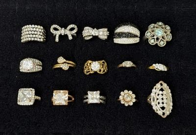 15 Mixed Tone Rhinestone Rings. A collection of 15 costume rings in mixed gold-tone and 