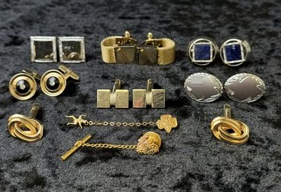 Vintage Cufflink & Tie Chains. A grouping of vintage men's cufflinks and tie accessories in 