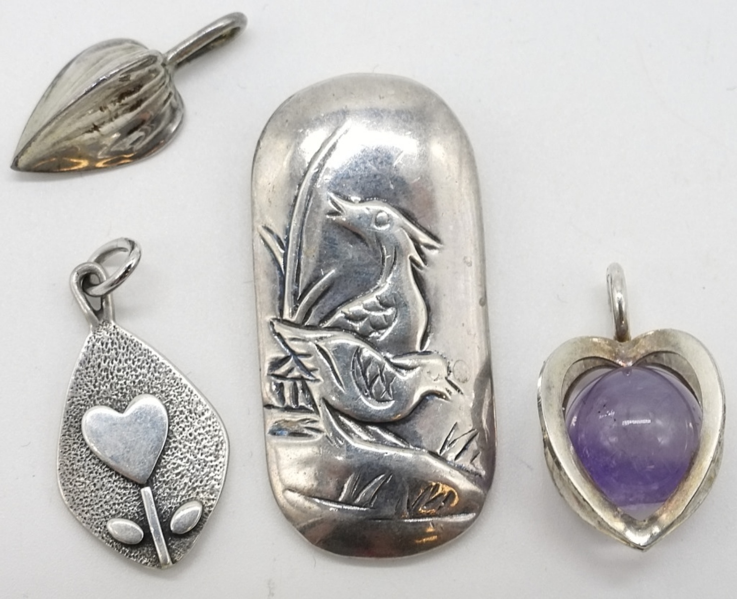 Four Sterling Pendants