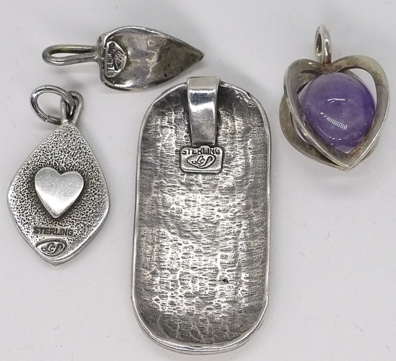 Four Sterling Pendants