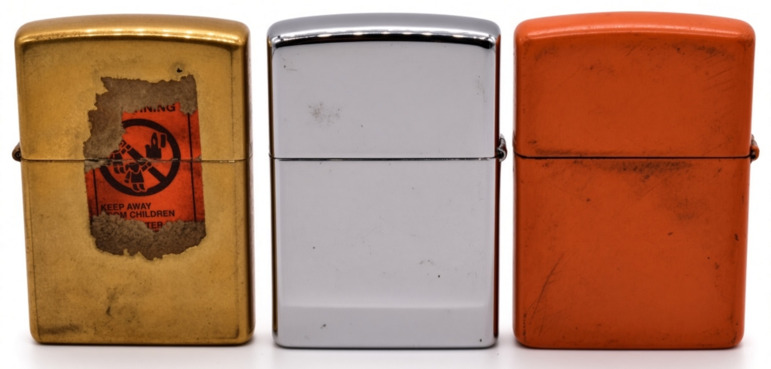 Three Camel Zippo Lighters, Gold, Chrome, Orange