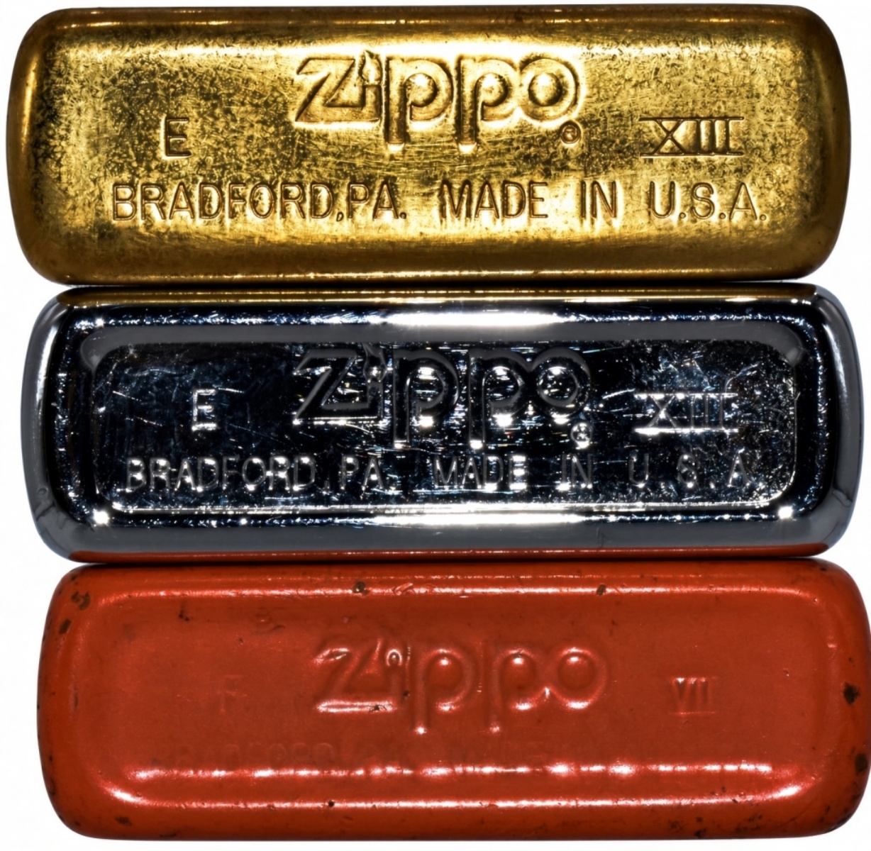 Three Camel Zippo Lighters, Gold, Chrome, Orange
