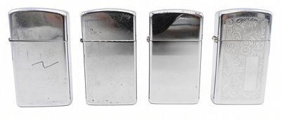 4 Slim Zippo Lighters, Fired. Four Zippo Slim lighters in brushed chrome, all fired and showing 